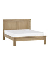 Julian Bowen Memphis limed oak bed with a mattress, on a white background