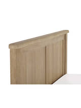 Memphis bed: panelled limed oak headboard with a rounded top rail, close up