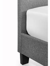 Merida bed: corner of the grey base and its dark foot, close up