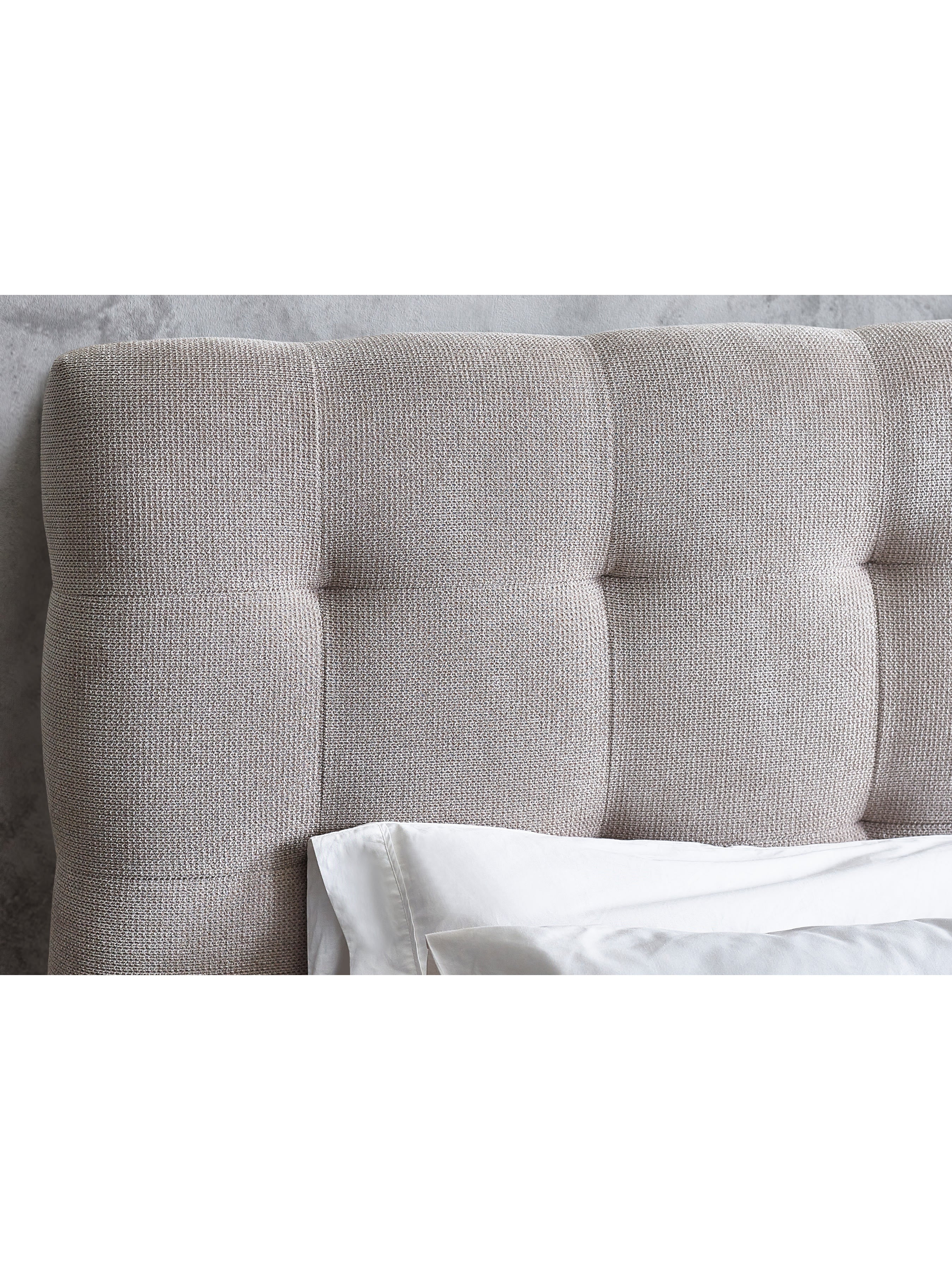 Odette bed: buttoned panels of the light taupe headboard, close up