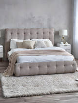 Julian Bowen Odette light taupe bed with a buttoned headboard and footboard, in a bedroom