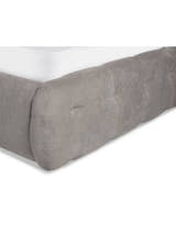 Odette bed: rounded corner of the light taupe footboard, close up