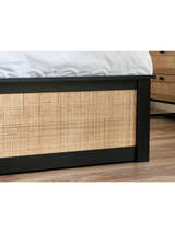 Padstow ottoman bed: black footboard with a woven rattan panel, close up