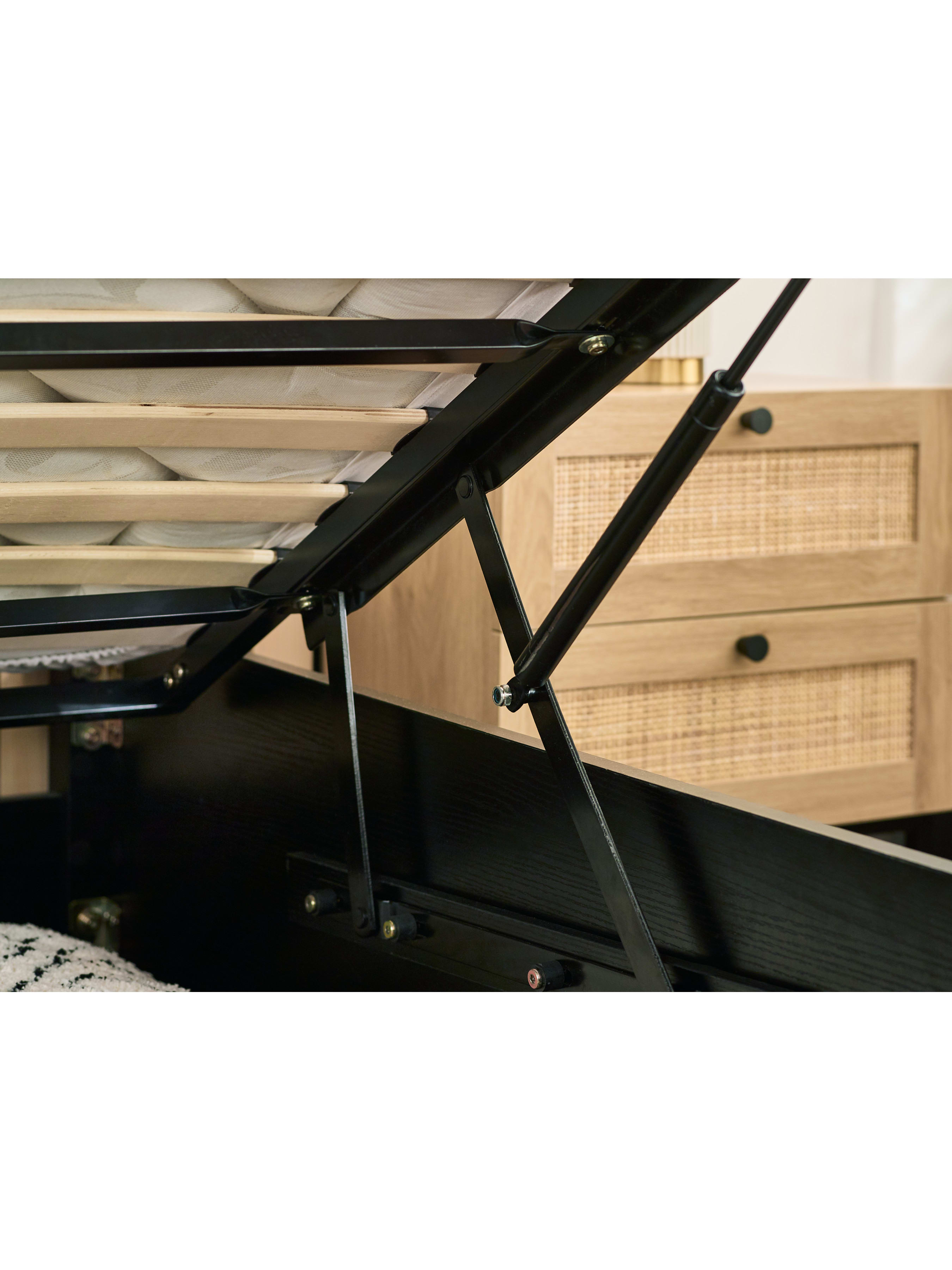 Padstow ottoman bed: gas struts of the raised base in a black frame, close up