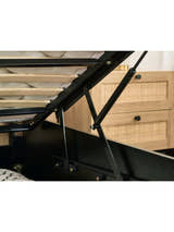 Padstow ottoman bed: gas struts of the raised base in a black frame, close up
