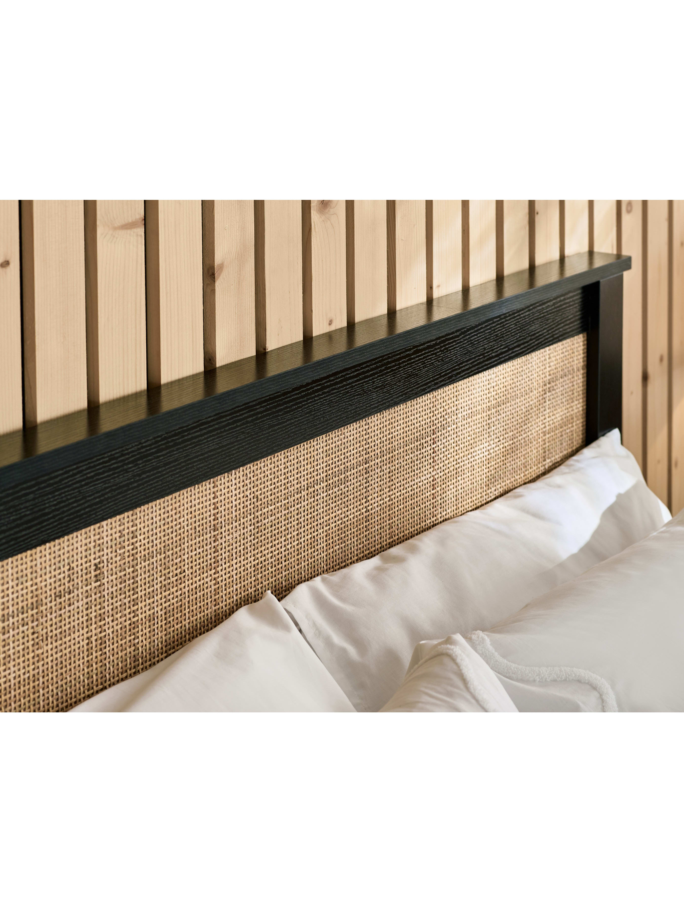 Padstow ottoman bed: woven rattan headboard panel in a black frame, close up