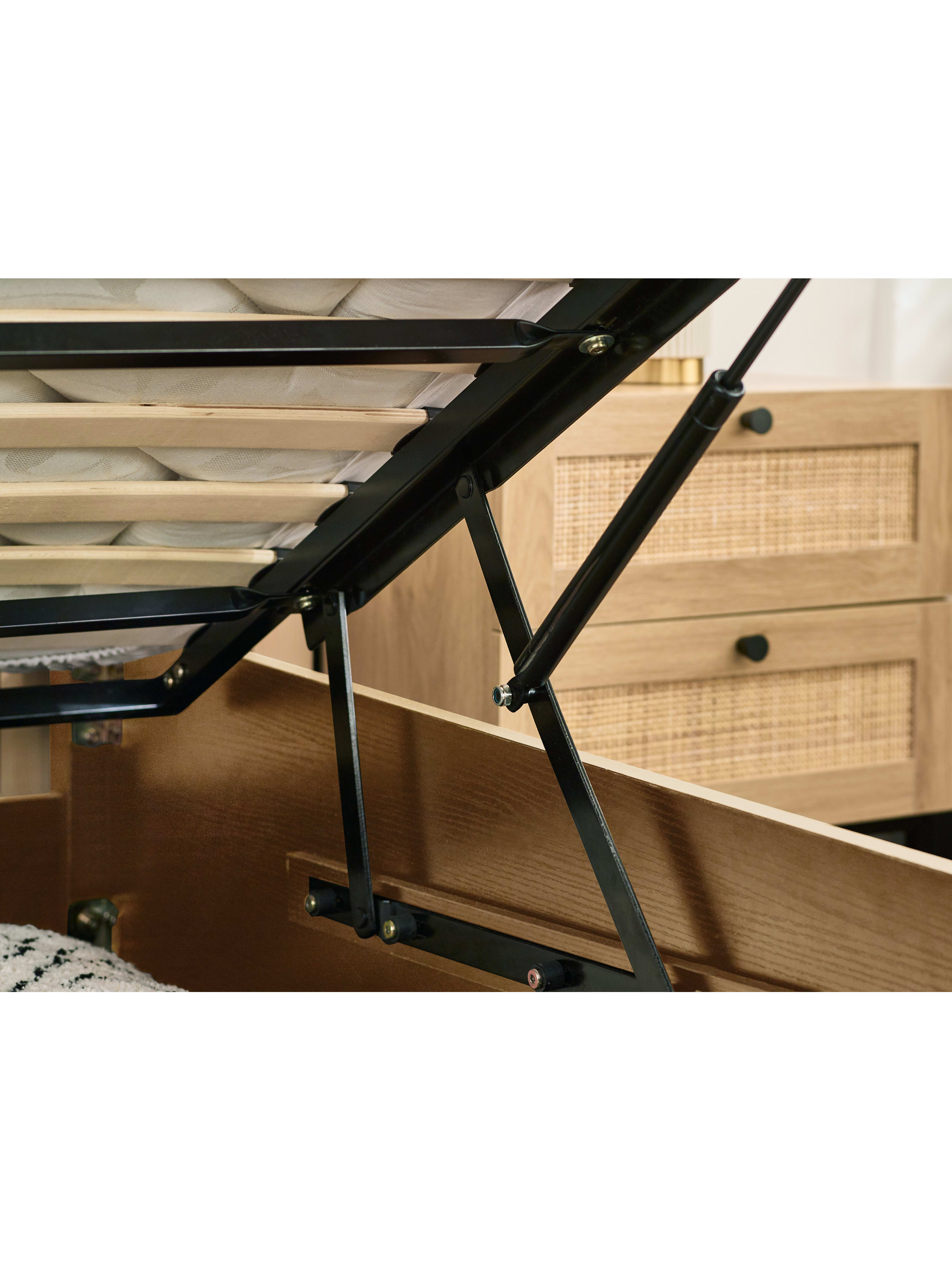 Padstow ottoman bed: gas struts of the raised base over the storage, close up