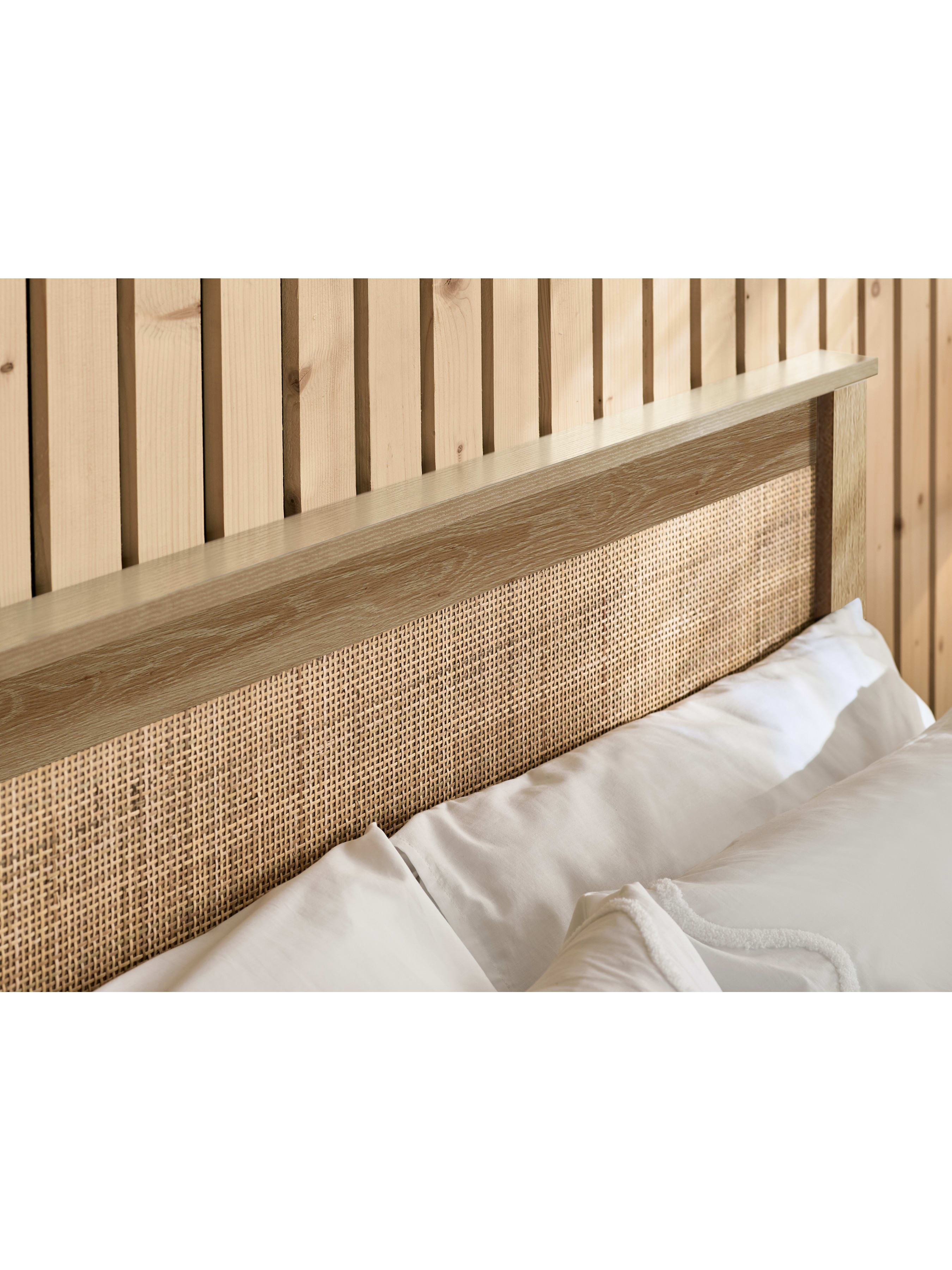 Padstow ottoman bed: woven rattan headboard panel in an oak effect frame, close up