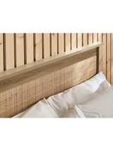 Padstow ottoman bed: woven rattan headboard panel in an oak effect frame, close up