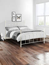 Julian Bowen Rebecca stone white metal bed, in a bright bedroom with a wooden floor