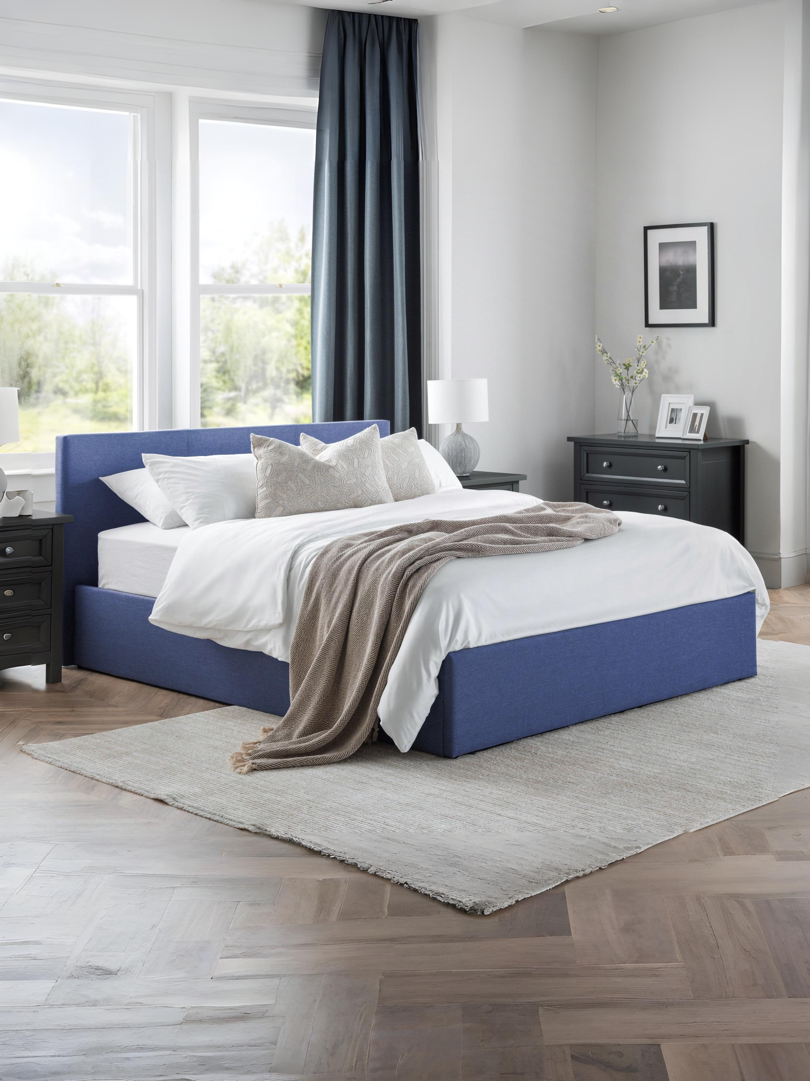 Julian Bowen Rialto ottoman bed in blue linen, made up in a bright bedroom