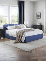 Julian Bowen Rialto ottoman bed in blue linen, made up in a bright bedroom