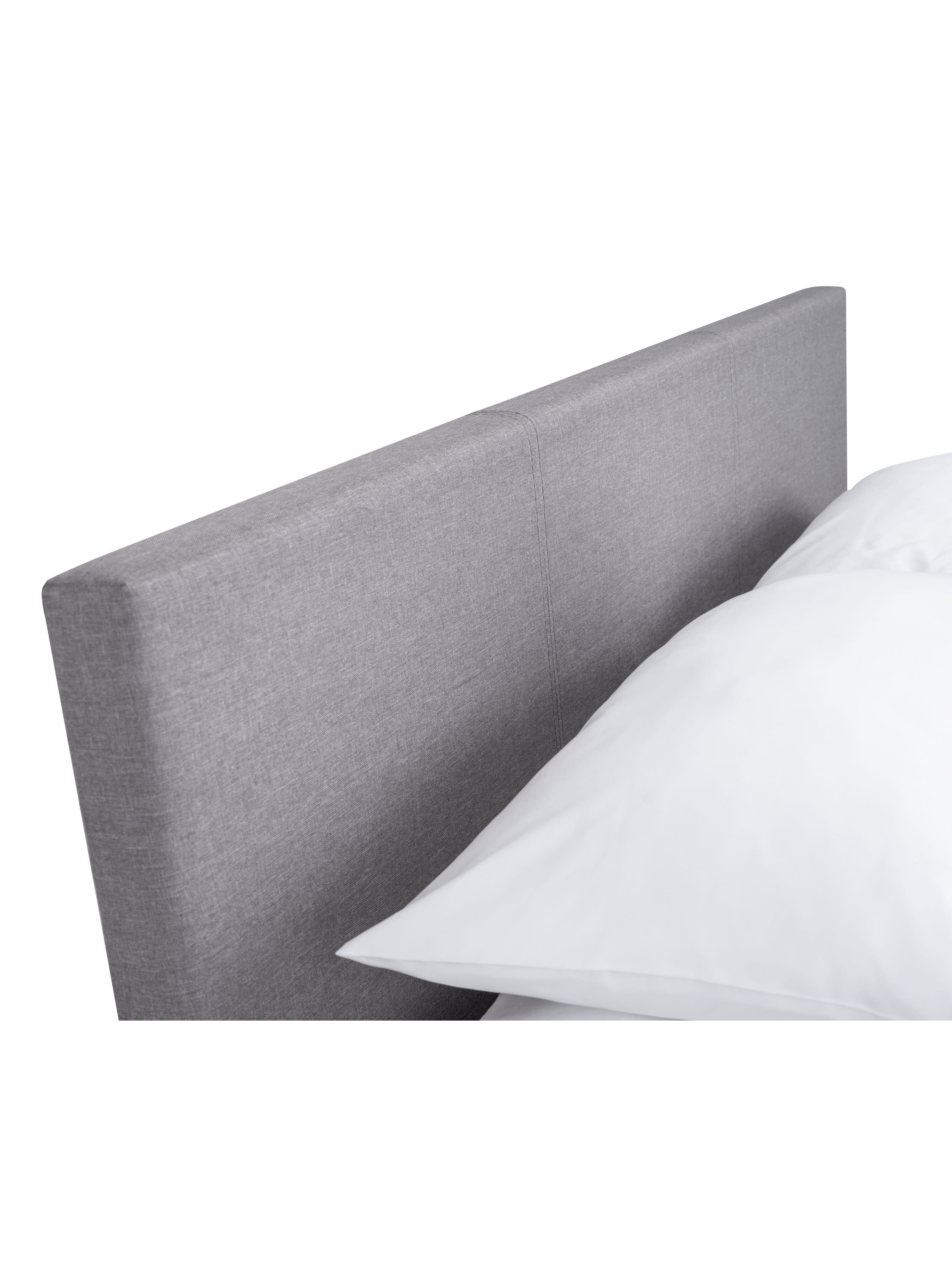 Rialto ottoman bed: the grey linen padded headboard with a pillow, close up