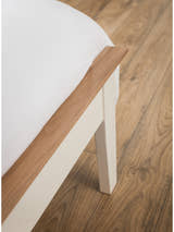 Salerno bed: solid oak capping on the ivory footboard and leg, close up