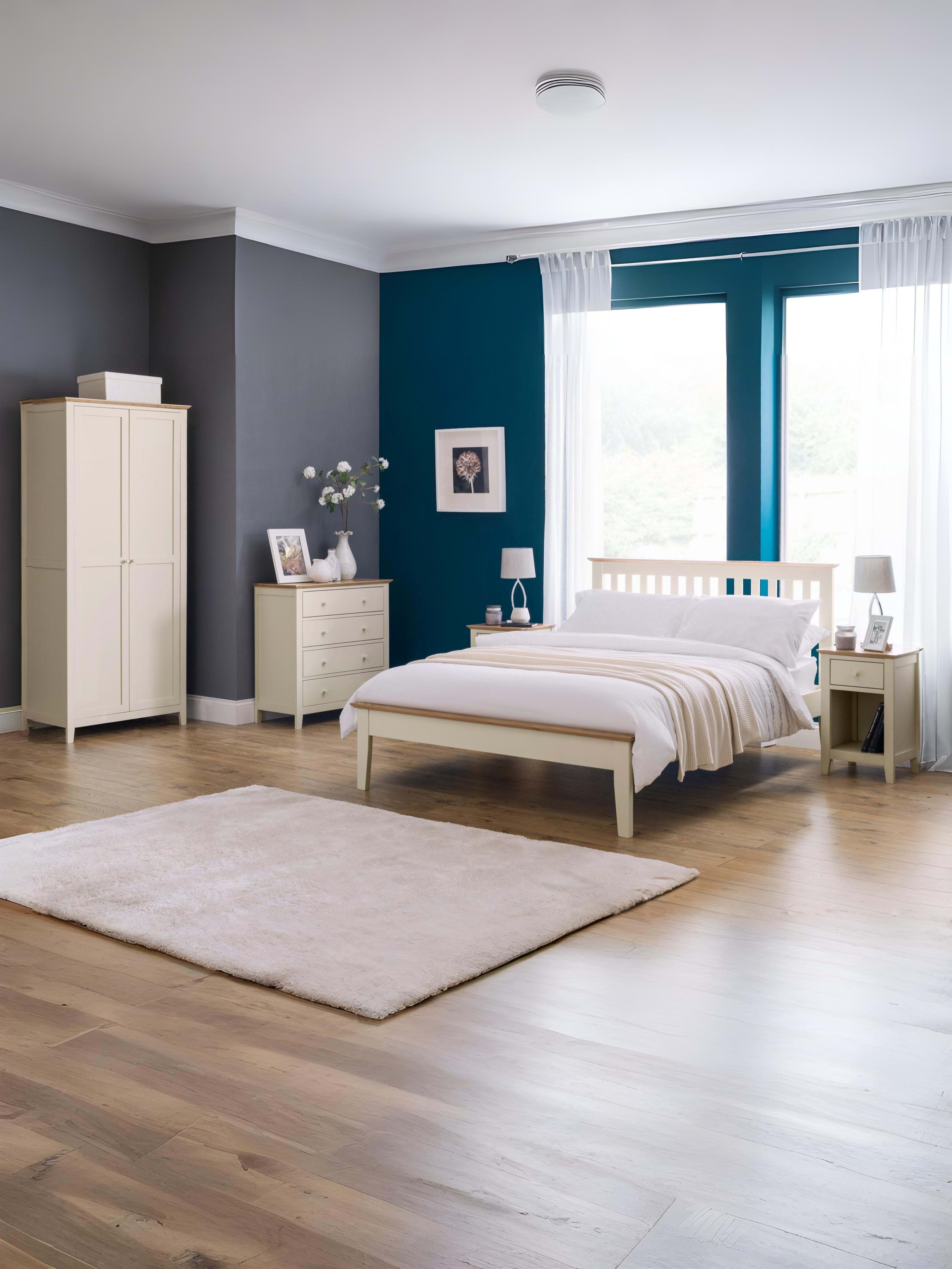Julian Bowen Salerno ivory and oak bed in a large bedroom with matching furniture, wide view
