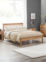 Julian Bowen Salerno shaker bed in natural oak, in a bedroom with a grey wall