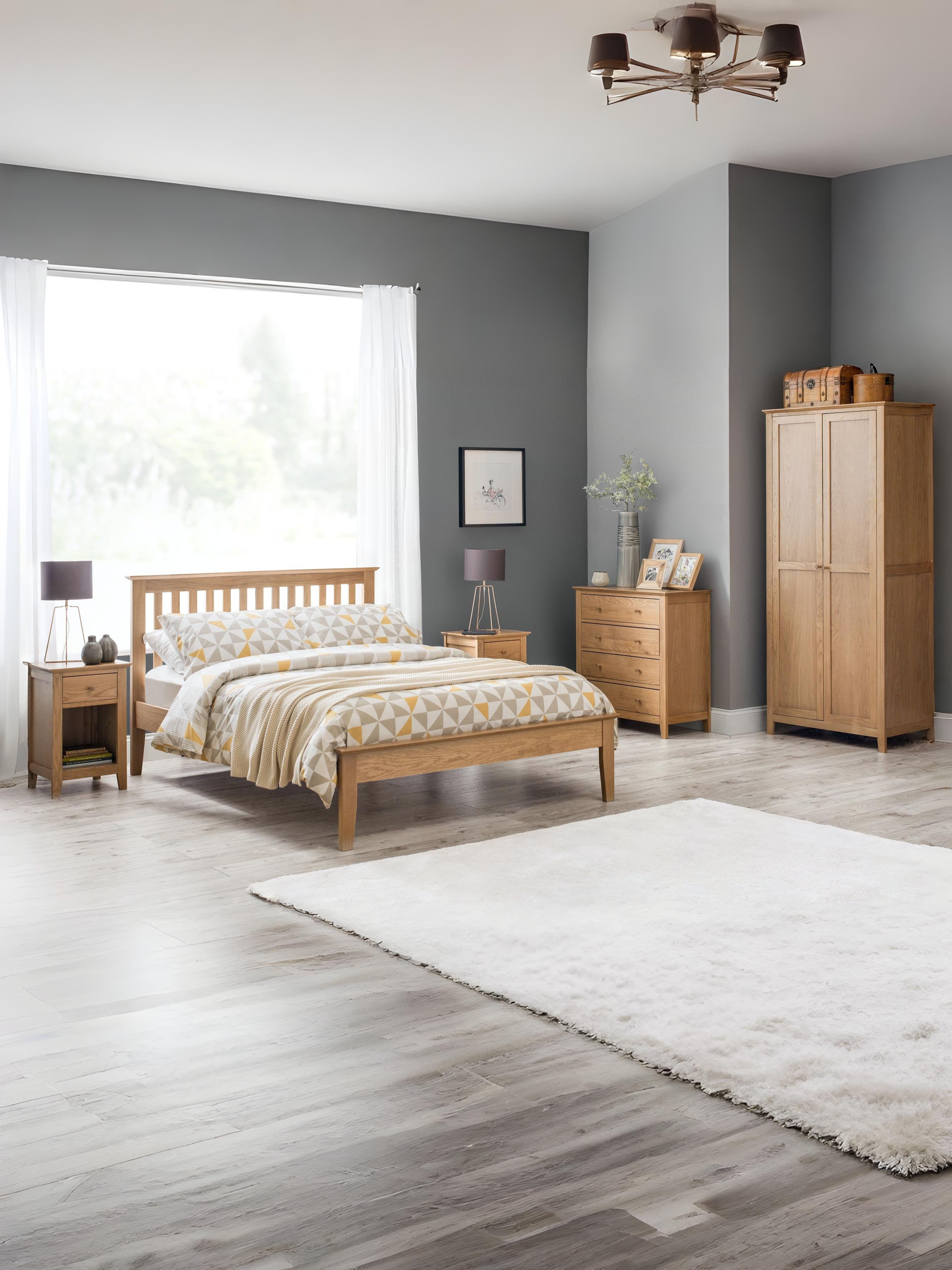 Julian Bowen Salerno natural oak bed in a large bedroom with an oak wardrobe, wide view