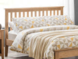 Julian Bowen Salerno natural oak slatted headboard in a bedroom, close up