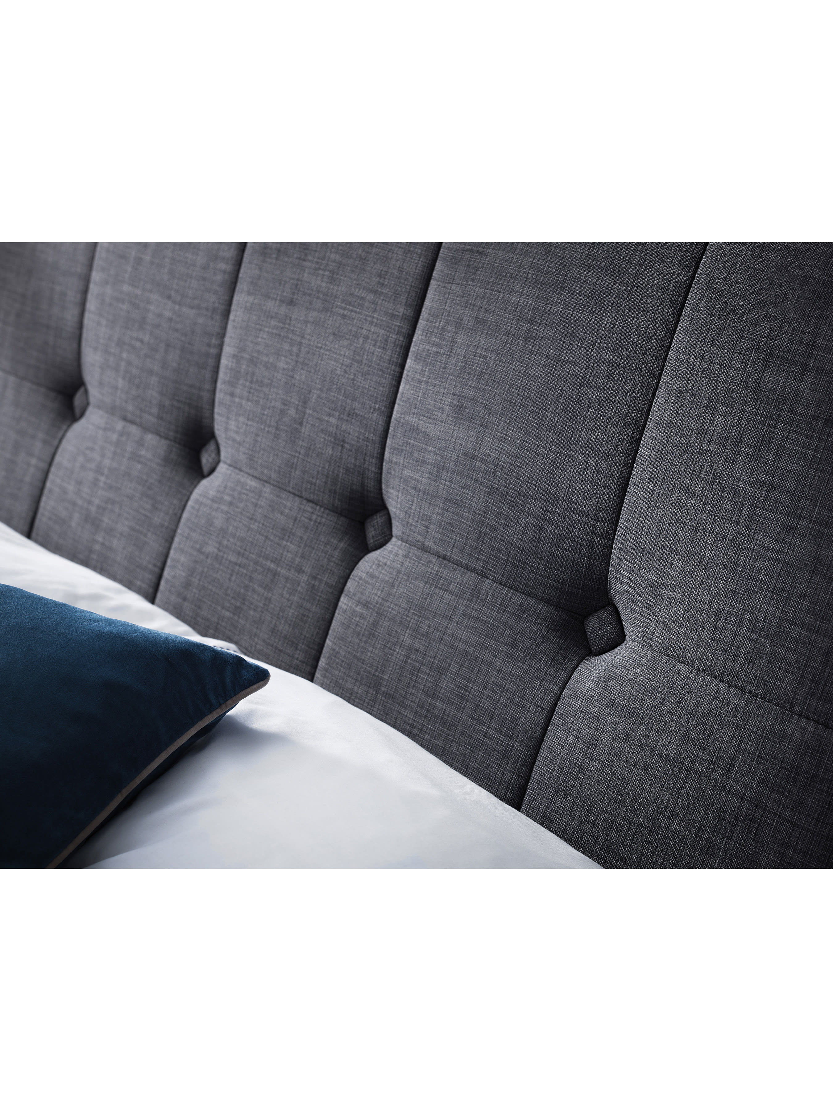 Sorrento bed: the buttoned slate linen headboard with a pillow, close up