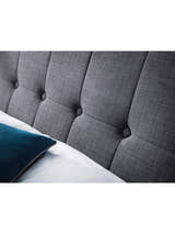 Sorrento bed: the buttoned slate linen headboard with a pillow, close up