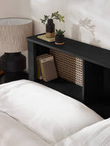 Sydney bed: open shelf and rattan-print panel of the black headboard, close up