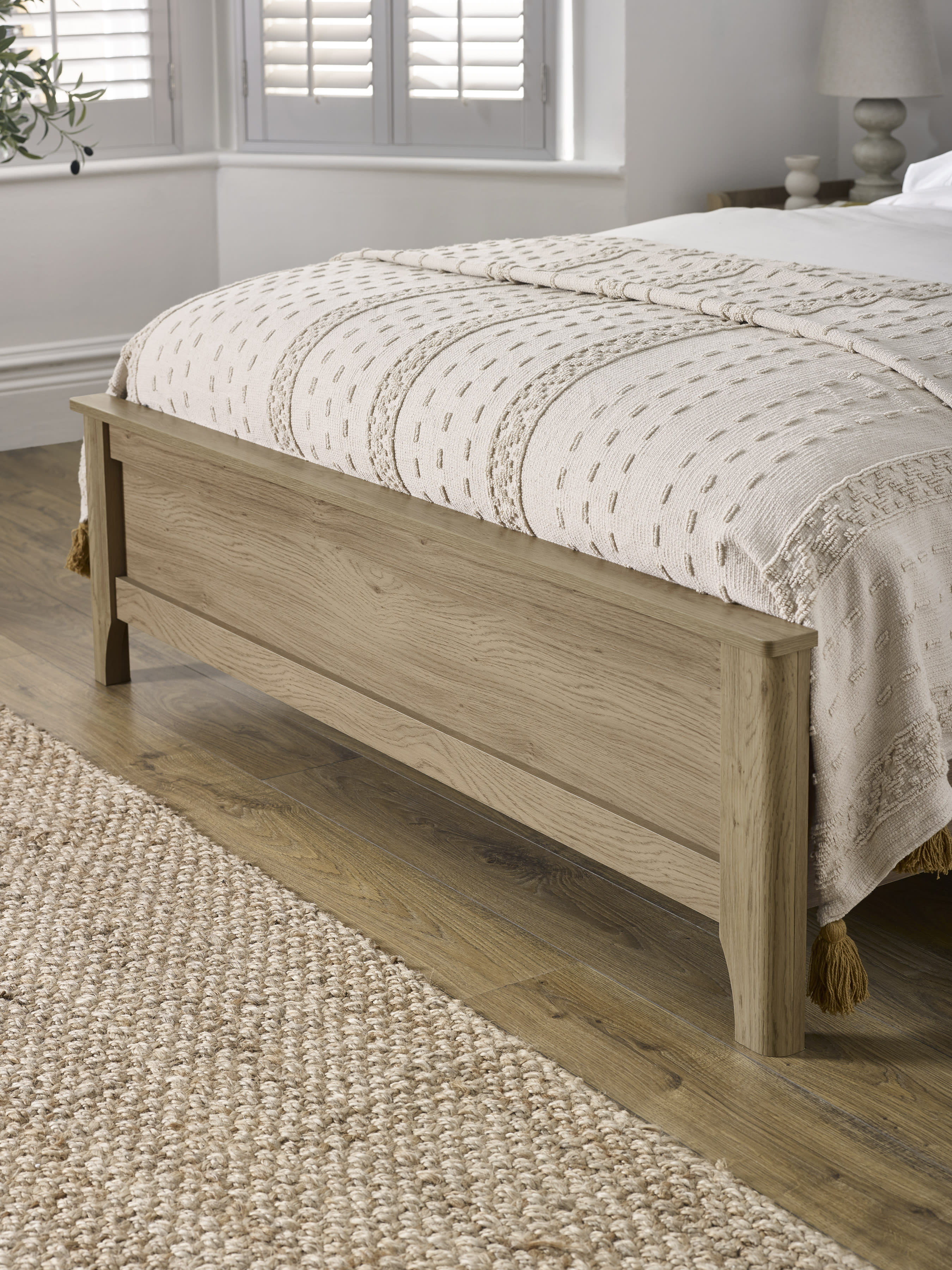 Sydney bed: oak effect footboard with a softly shaped leg, close up