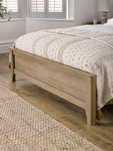 Sydney bed: oak effect footboard with a softly shaped leg, close up