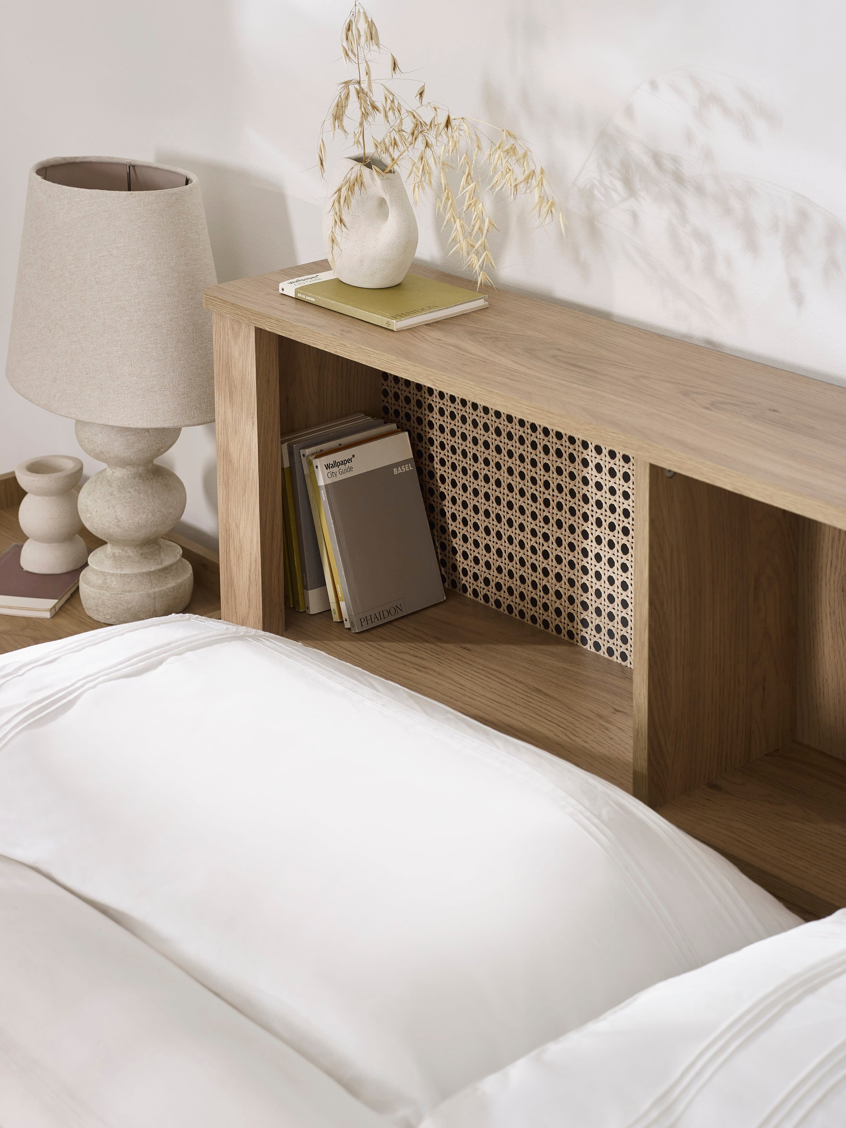 Sydney bed: open shelf and rattan-print panel of the oak effect headboard, close up