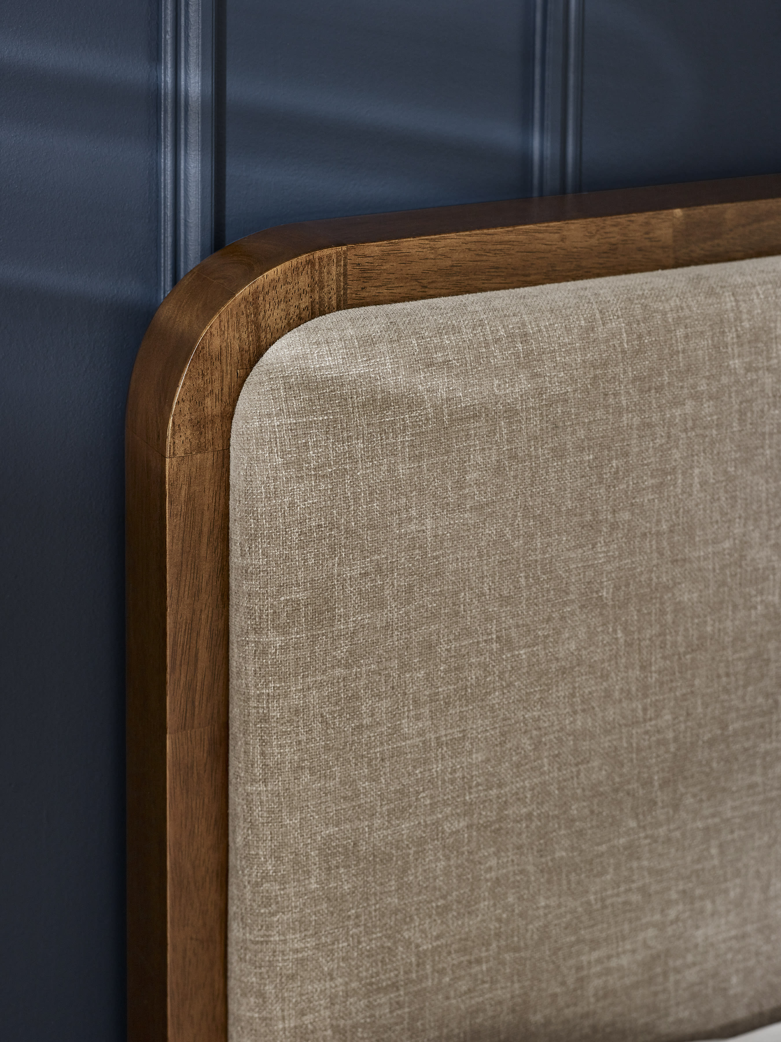 Walden bed: grey chenille headboard and walnut effect frame, close up