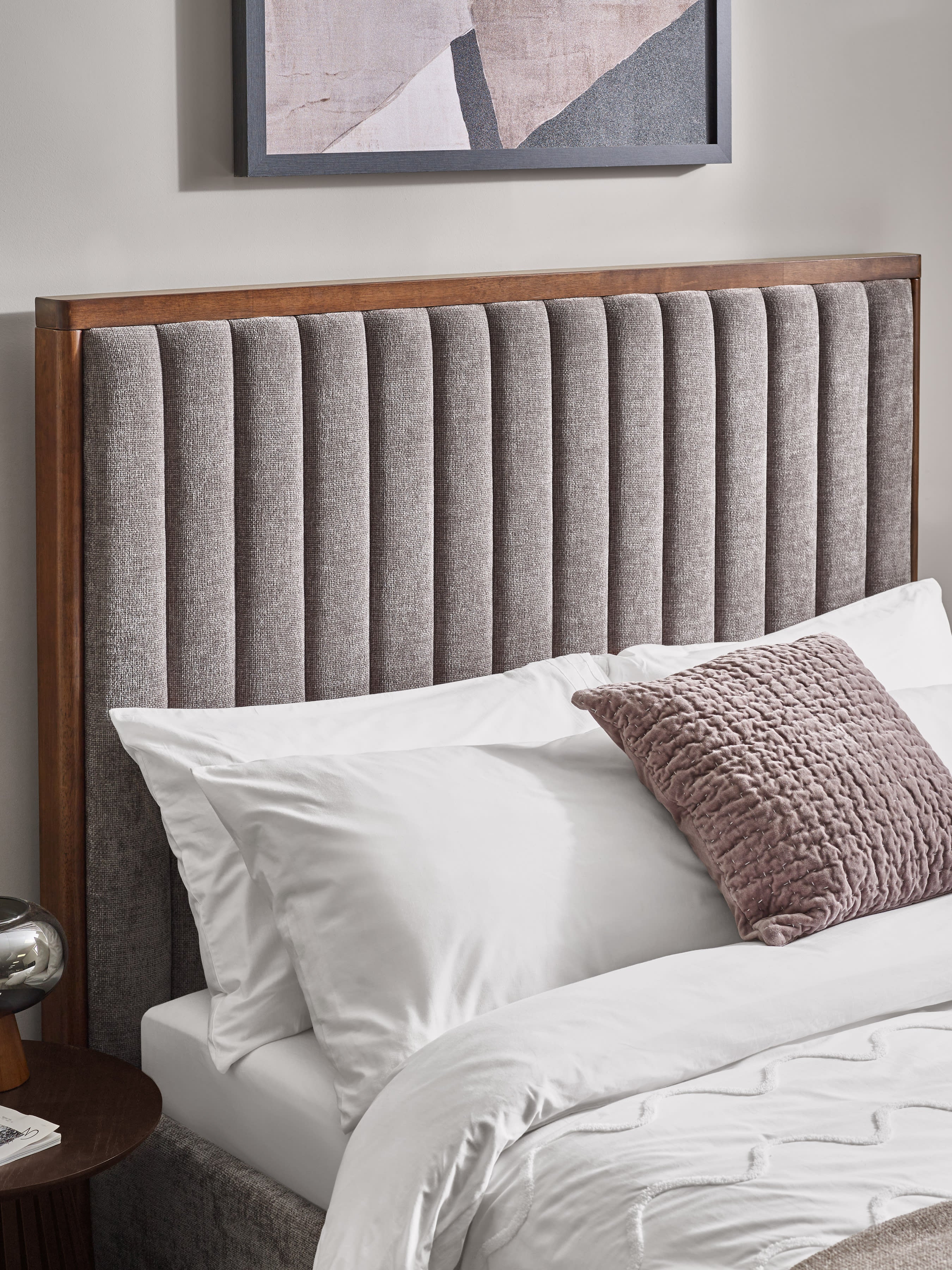 Whitmore bed: the channelled grey chenille headboard in its wooden frame, with pillows