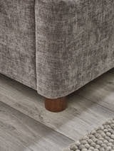 Whitmore bed: the grey chenille base and round wooden foot, close up