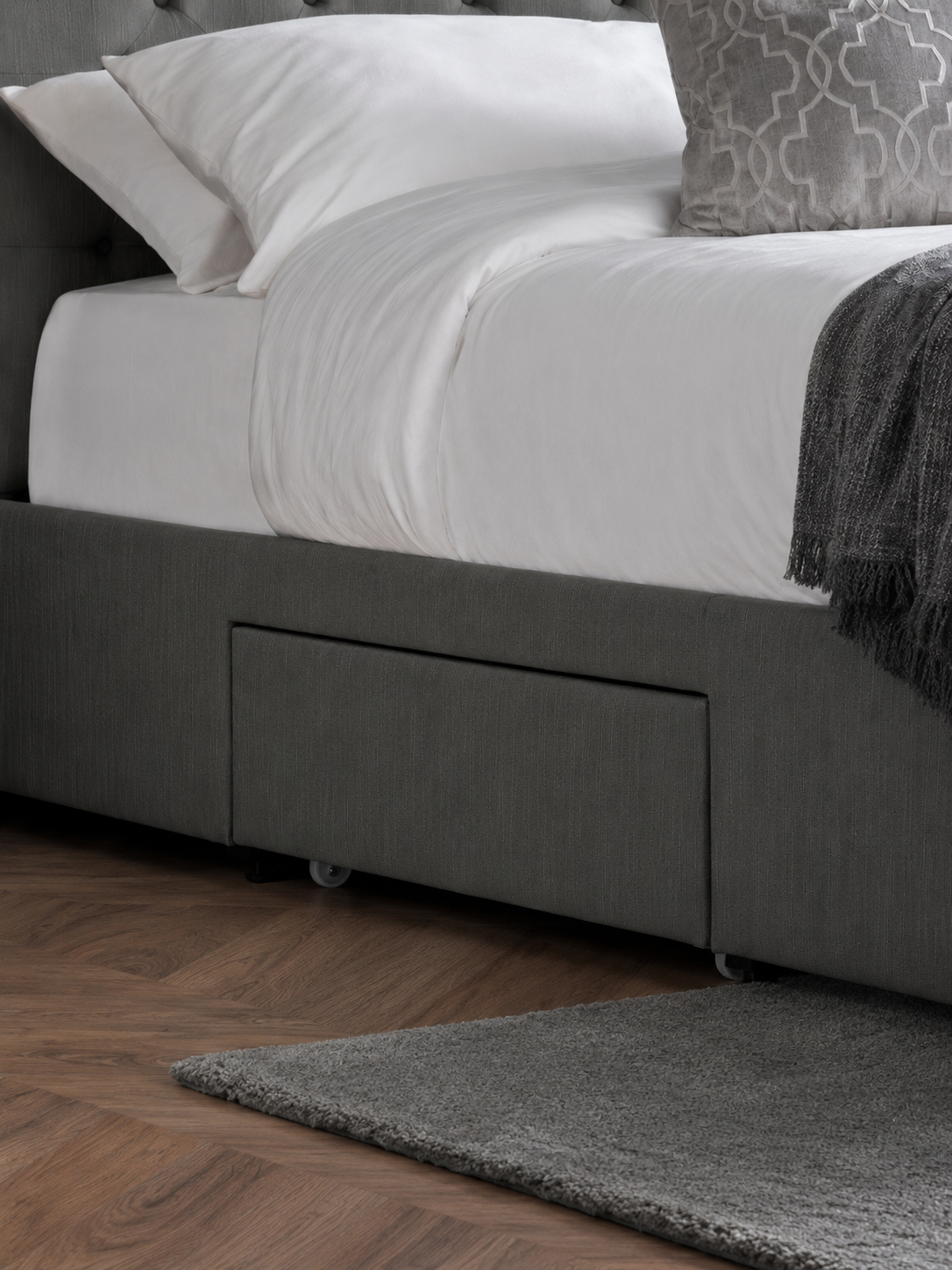 Wilton bed: a drawer on the side of the dark grey base, close up