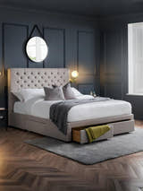Julian Bowen Wilton 4 drawer bed in light grey with a drawer open, in a dark panelled bedroom