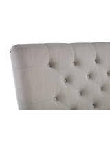 Wilton bed: the curved edge of the light grey buttoned headboard, close up