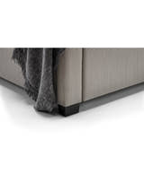 Wilton bed: corner of the light grey base and dark foot, close up