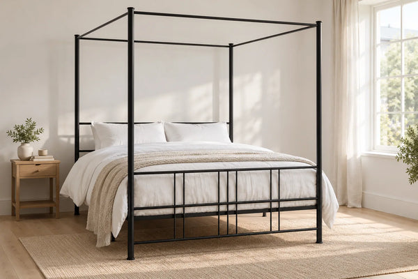 Knightsbridge black four poster iron bed, shown in a bright UK bedroom