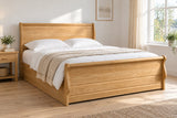 Ealing solid oak ottoman bed in a natural oak finish, king size, in a bright UK bedroom (bedding for illustration, mattress not included)