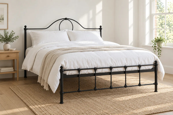 Lambeth black iron bed frame, shown in a bright UK bedroom