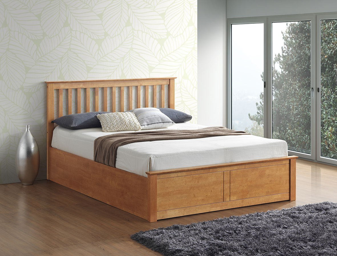 Ruislip wooden ottoman bed in oak, closed, in a bedroom