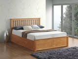 Ruislip wooden ottoman bed in oak, closed, in a bedroom