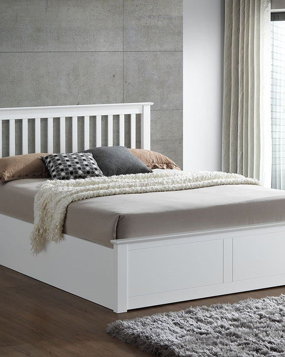 Ruislip wooden ottoman bed in white, closed, in a bedroom