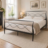 Ladbroke black metal bed frame in king size with curved posts and a wave headboard, in a bright Victorian bedroom (AI-generated illustration of this frame; bedding for illustration, mattress not included)