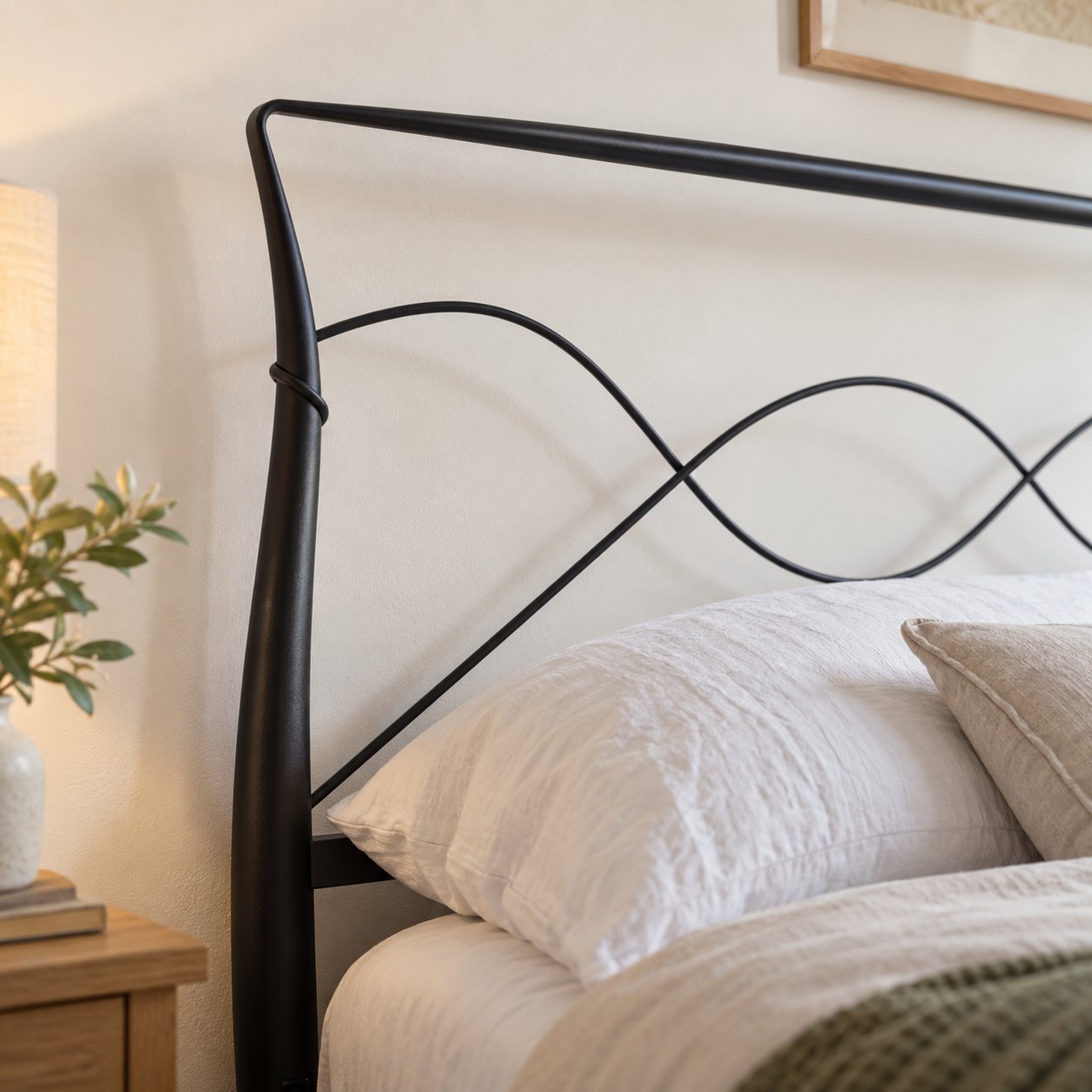 Close-up of a curved post and the wave wires on the Ladbroke headboard, matte black finish (AI-generated illustration of this frame; bedding for illustration, mattress not included)