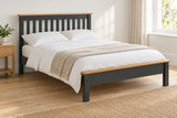 Balham grey and oak wooden bed frame with a low foot end, shown in a bright UK bedroom