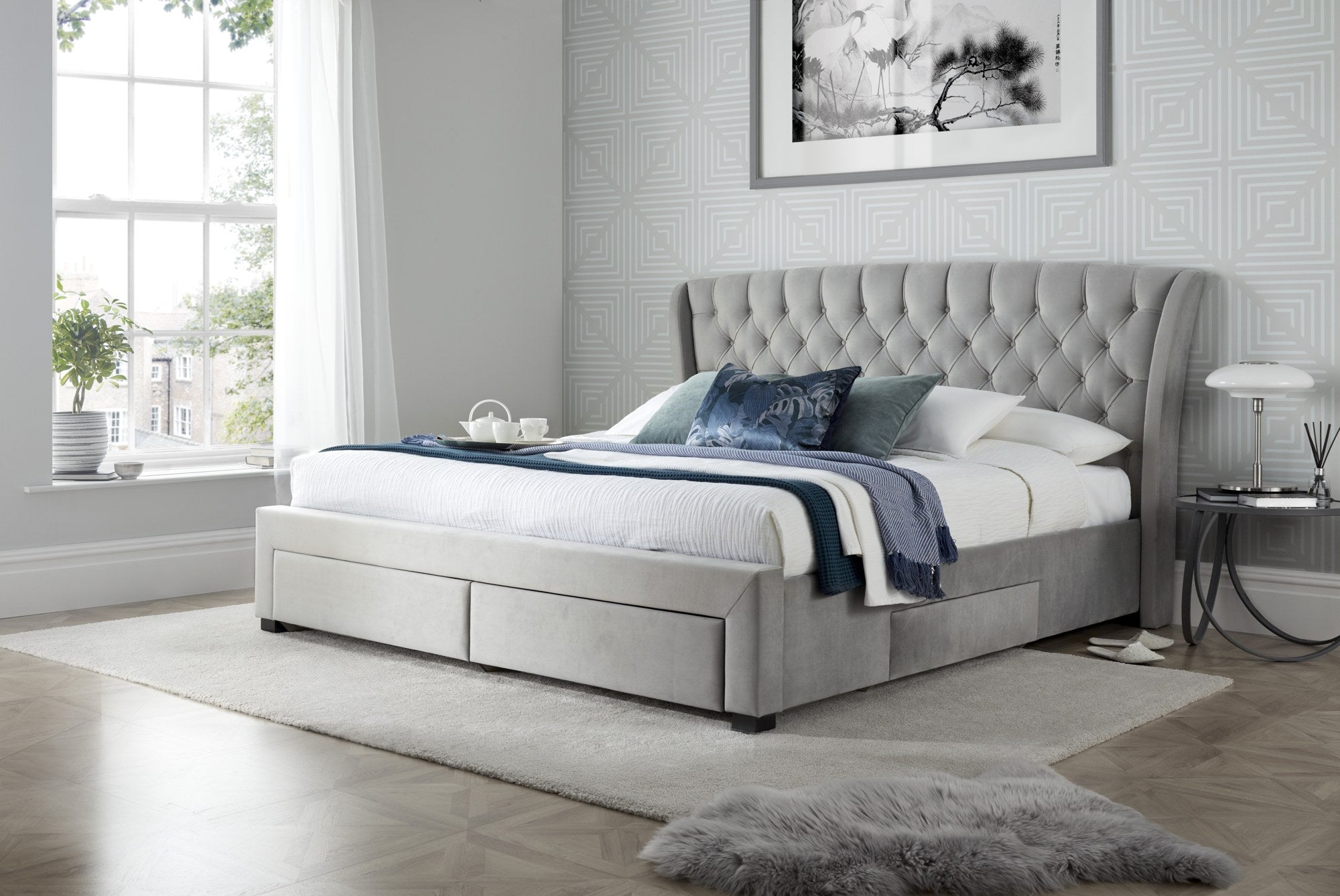 Hendon velvet storage bed in grey velvet, with the drawers closed, in a bedroom