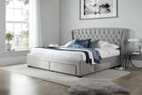 Hendon velvet storage bed in grey velvet, with the drawers closed, in a bedroom