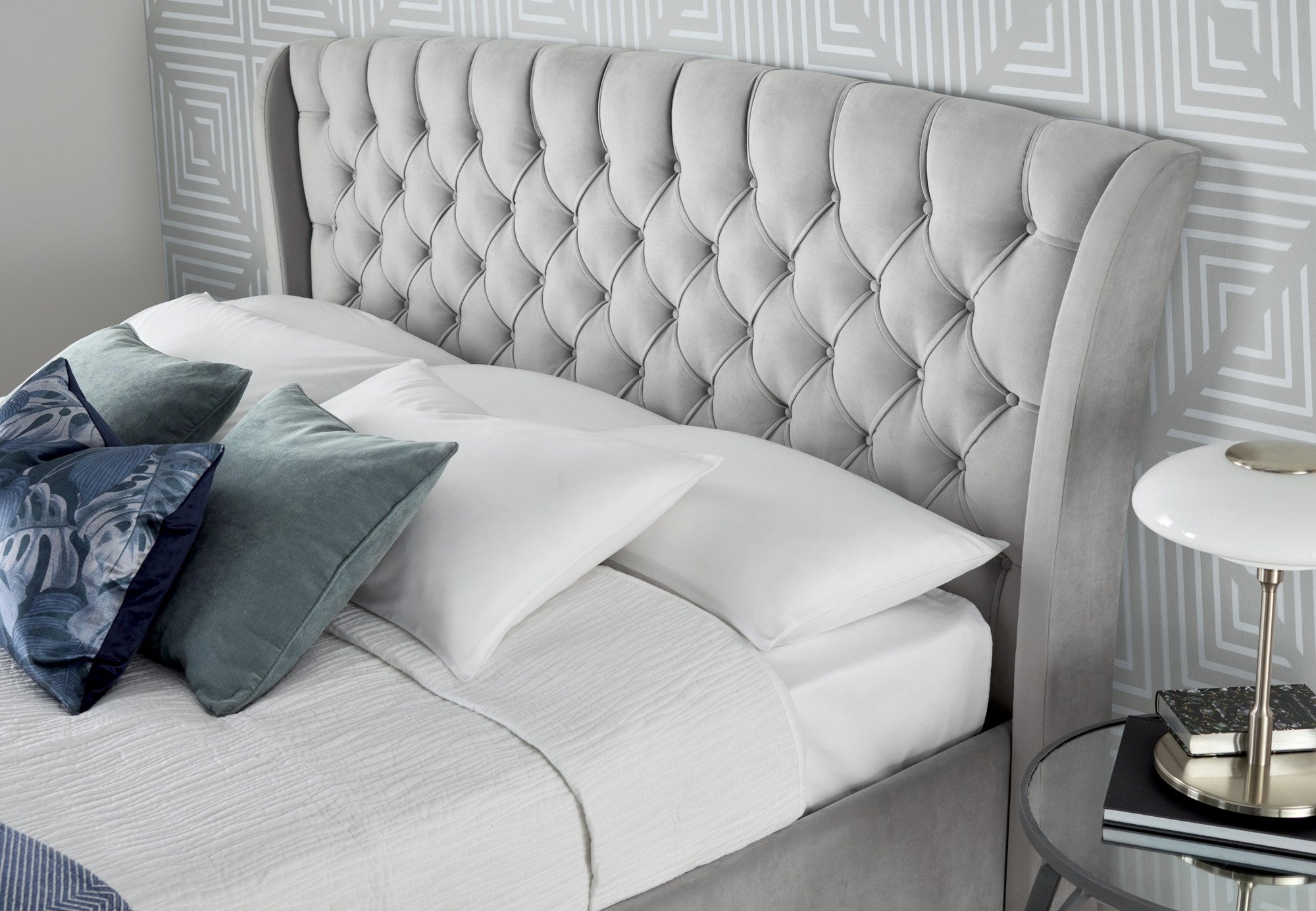 Hendon velvet storage bed in grey velvet, close-up of the buttoned winged headboard