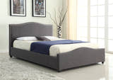 Bexley grey fabric ottoman bed with a curved studded headboard, in a bedroom