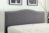 Bexley ottoman bed: curved grey fabric headboard with a studded edge, close up