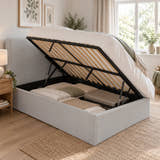 Brompton ottoman bed opened from the side on gas struts, with storage under the whole base (AI-generated illustration of this frame; bedding for illustration, mattress not included)